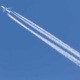 How are contrails left by airplanes generated and affected?